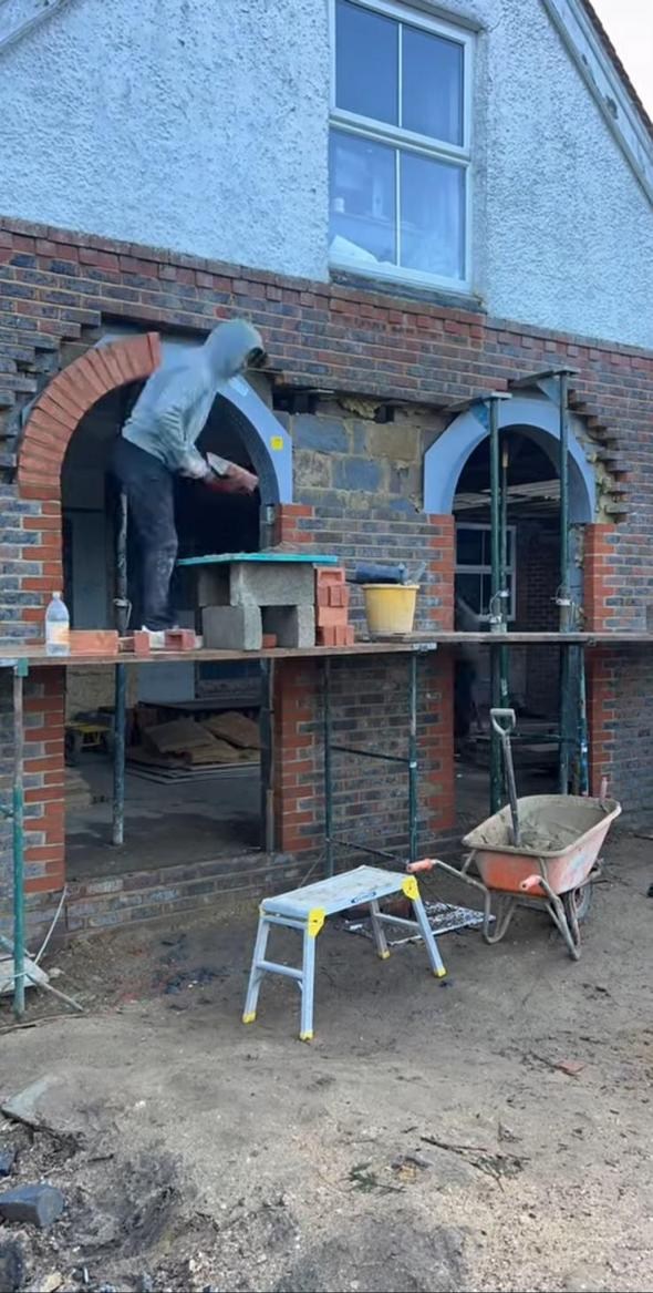 Builder forming detailed brick arches
