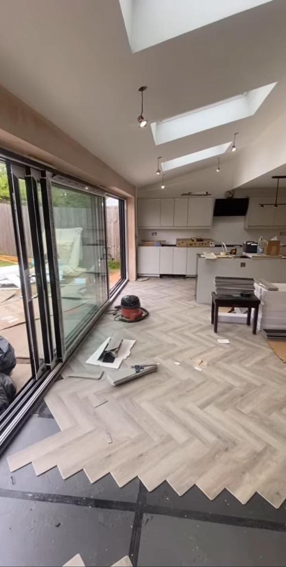 Bright kitchen extension with roof lights, bi-fold doors and herringbone flooring