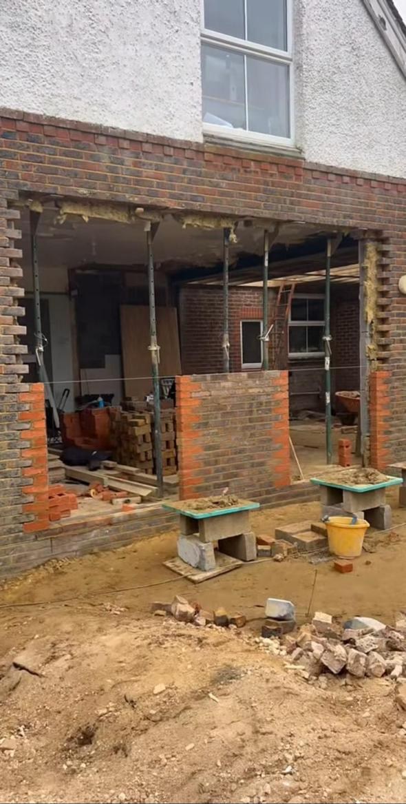 Large structural opening at rear of house supported during construction